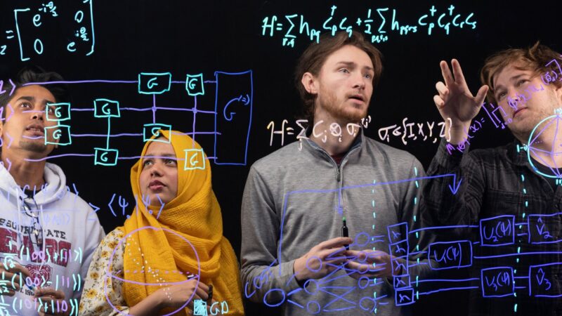 Missouri State University students working through quantum equations.