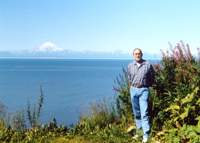 Photo of Tom Plymate in front of Redoubt Volcano, Alaska
