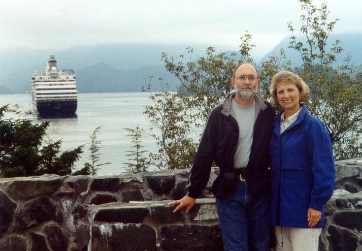 Photo of Tom & Lynda Plymate in front of Sitka harbor, Alaska